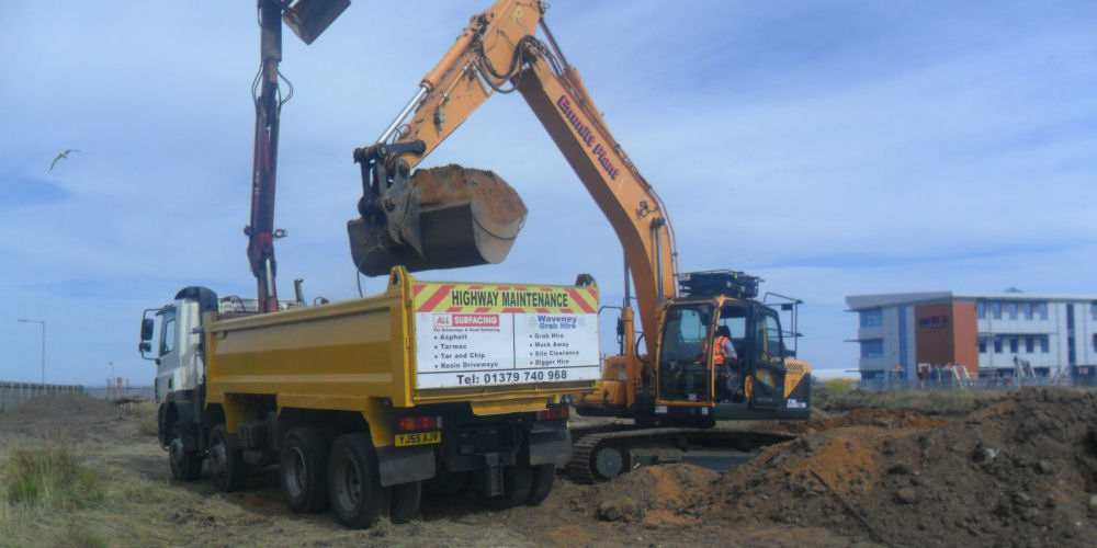 a grab lorry removing waste