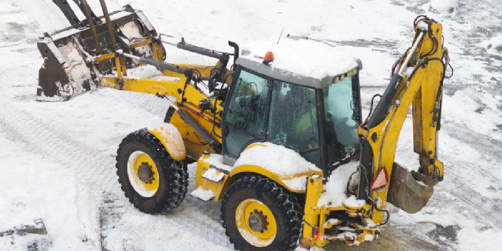 a digger clearing snow